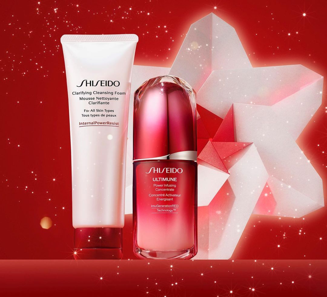Still life of Shiseido skincare products: Clarifying Cleansing Foam and Ultimune Power Infusing Concentrate on a red surface.