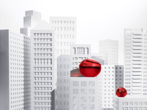 Artistic render featuring two red cosmetic jars against a backdrop of white, minimalist building structures in an urban setting.