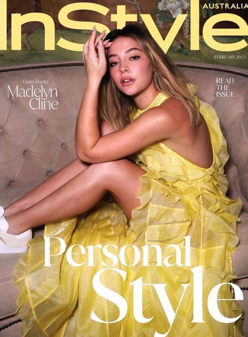 Madelyn Cline is seated on an ornate chair, wearing a yellow dress for the InStyle Australia cover, with illustrated floral background.