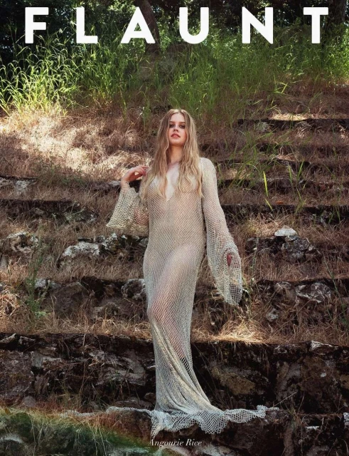 An image from Flaunt magazine features a fair-skinned adult woman with long blonde hair wearing a sheer gown, standing on stone steps.