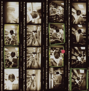 Contact sheet of black and white photographic film frames showing a person in a store by photographer Levi Walton.