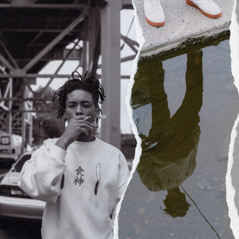 Black-and-white portrait of a young adult man smoking against a city backdrop with a split-screen view of his reflection in a puddle.