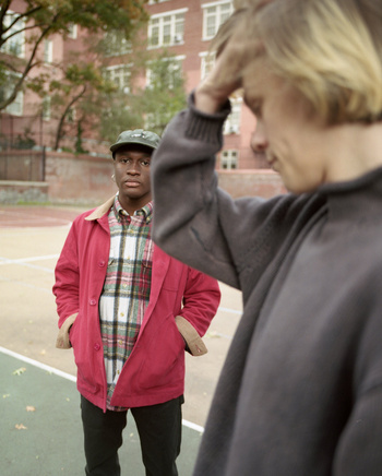 Two young men outdoors with a red jacket and plaid shirt, shot by Levi Walton