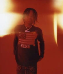 Portrait of young Black man wearing graphic sweater with American flag motif photographed by Levi Walton.