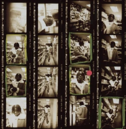 Contact sheet of black and white photographic film frames showing a person in a store by photographer Levi Walton.
