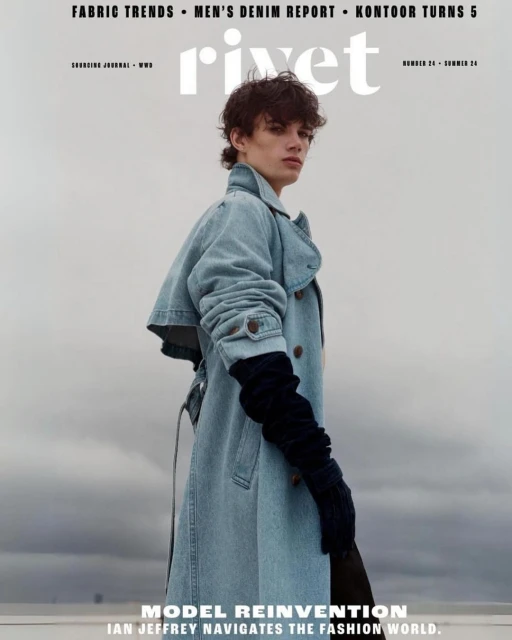Magazine cover featuring a young adult male model in a denim trench coat and gloves against a cloudy sky, promoting Rivet fashion magazine.