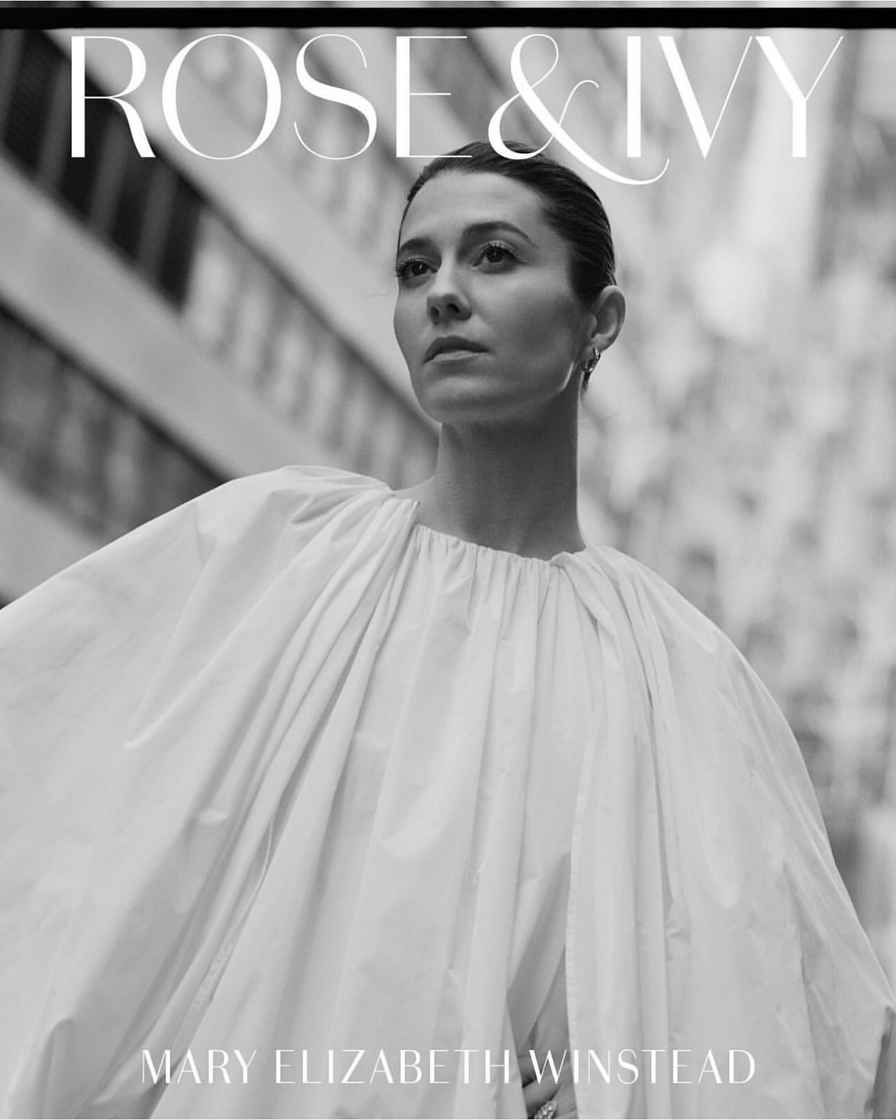 Black and white portrait of Mary Elizabeth Winstead wearing a white top against a blurred urban backdrop and magazine cover typography.