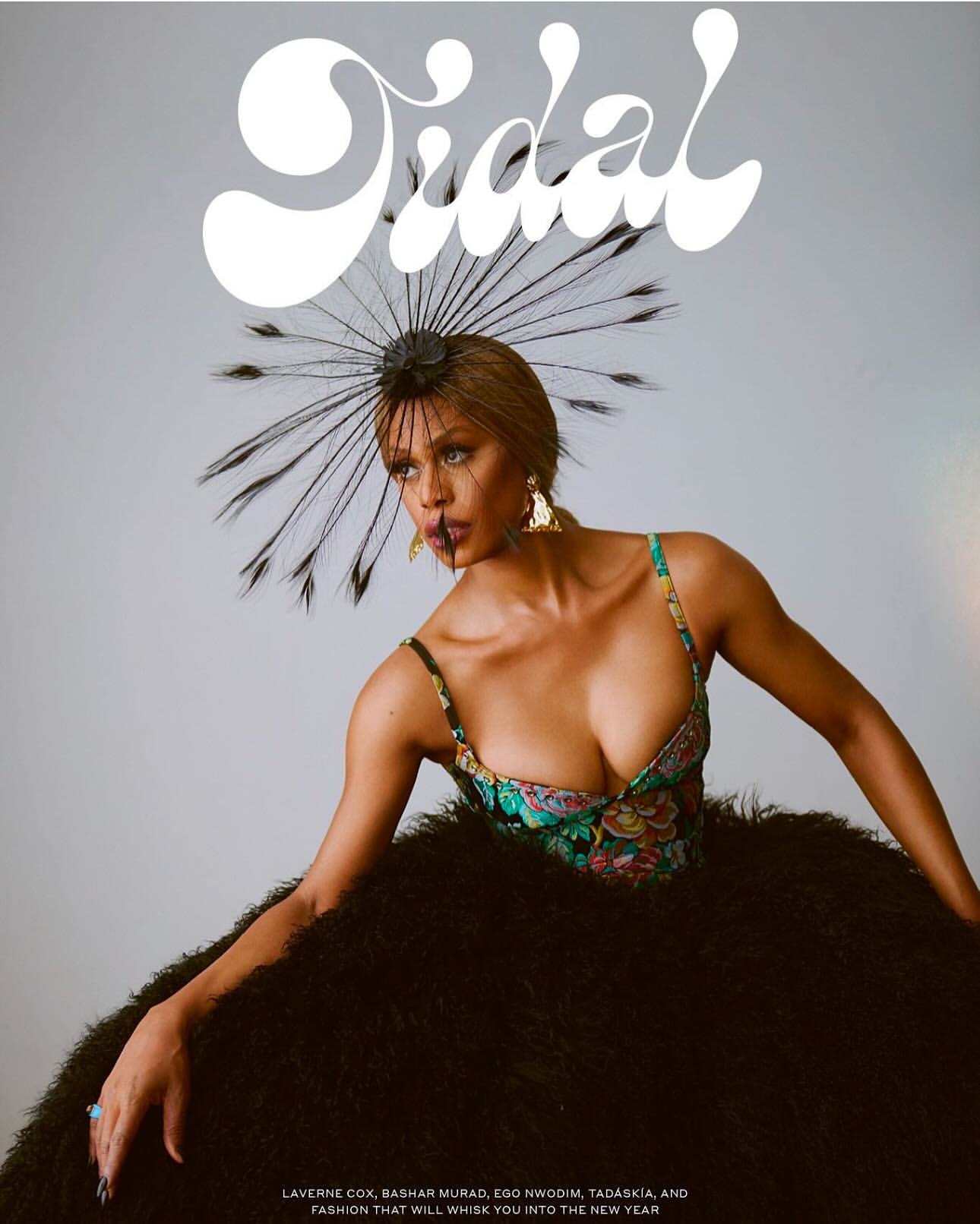 Fashion magazine cover featuring a woman with dark hair in an elegant black dress with a feather headpiece and floral bodice.