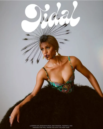 Fashion magazine cover featuring a woman with dark hair in an elegant black dress with a feather headpiece and floral bodice.