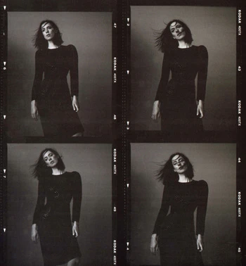 Black and white portrait of a woman in a black dress, captured across four frames of Kodak film with hair slightly blowing in the wind.