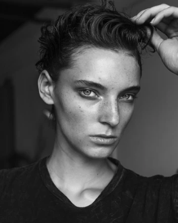 Monochrome portrait of a woman with wet hair running her hand through it, captured by Matthew Priestley.