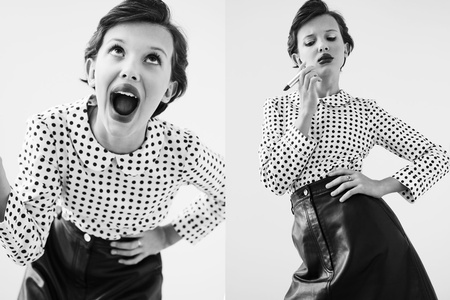 Black and white portrait of a young woman in a polka dot shirt and black skirt looking fashionable and expressive in a photo studio.