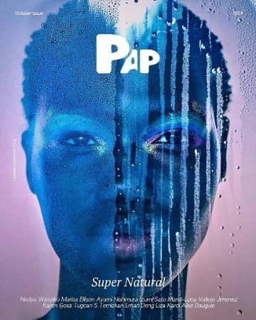 Close-up portrait of a Black woman's face seen through wet glass with dripping water drops, shot by Nadya Wasylko.