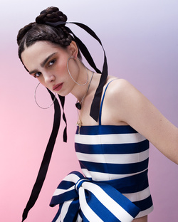 Woman in blue and white striped top with large bow and braided hair with black ribbons by photographer Nadya Wasylko