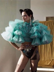 Model in voluminous teal ruffled tulle top and embellished fishnet bottoms photographed by Nadya Wasylko.