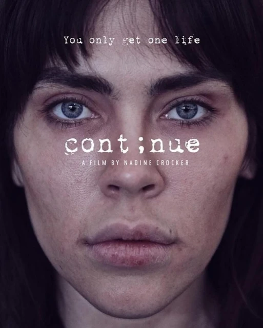 Close-up portrait of a young adult woman with brown hair and striking blue eyes, against a dark background, reminiscent of a film poster.