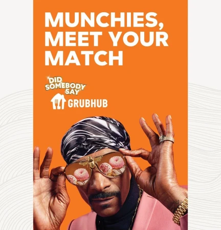 Snoop Dogg wears novelty donut glasses and a headscarf in a Grubhub advertisement with an orange backdrop and the Grubhub logo.