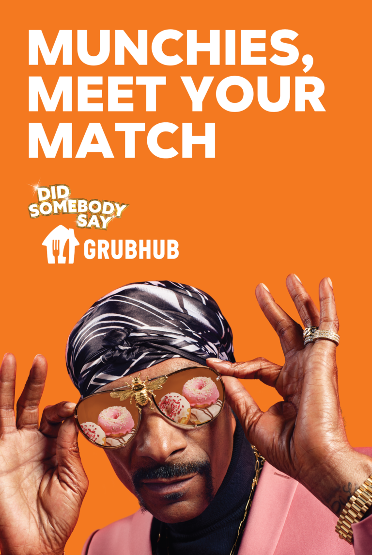Grubhub ad featuring a Black man with sunglasses reflecting donuts, wearing a headscarf and pink jacket against an orange background.