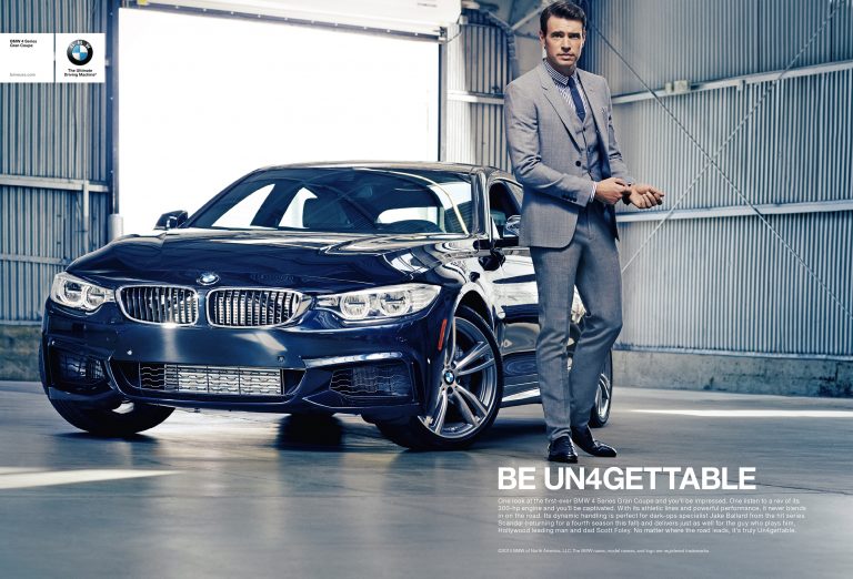 Luxury BMW coupe in glossy dark blue parked indoors, paired with a man in a gray suit, creating a high-end automotive advertisement.