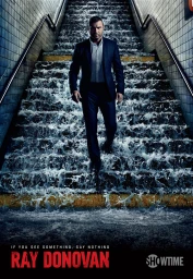 Man in a dark suit descending concrete subway stairs while water rushes down the steps around him