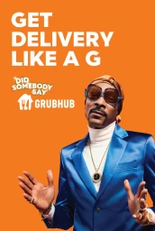 Snoop Dogg wearing a blue suit, white turtleneck, and headscarf against a vibrant orange background with bold white text.
