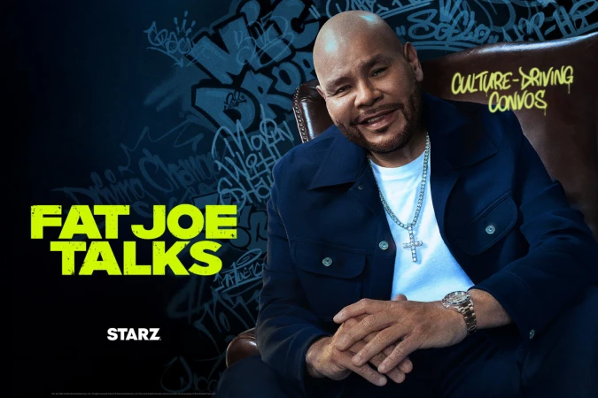 Fat Joe sits in a leather chair in front of graffiti-style art for promotion of his show "Fat Joe Talks" on Starz network.