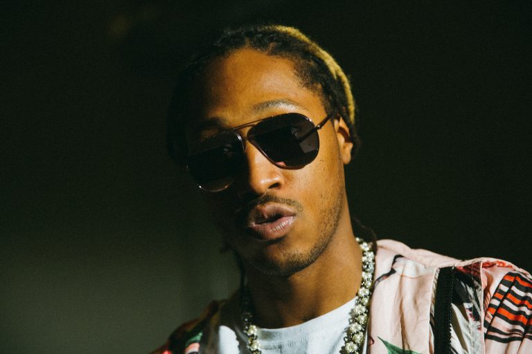 Portrait of Future wearing aviator sunglasses and a patterned shirt, photographed by G L Askew Ii.