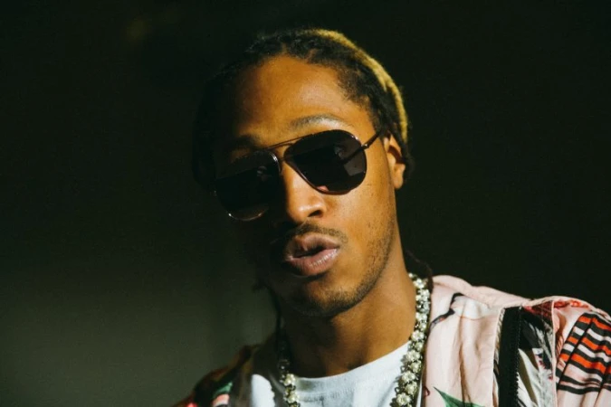 Portrait of Future wearing aviator sunglasses and a patterned shirt, photographed by G L Askew Ii.