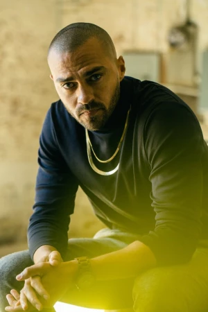 Portrait of Jesse Williams wearing a dark turtleneck and gold chain, photographed by G L Askew Ii in Los Angeles.
