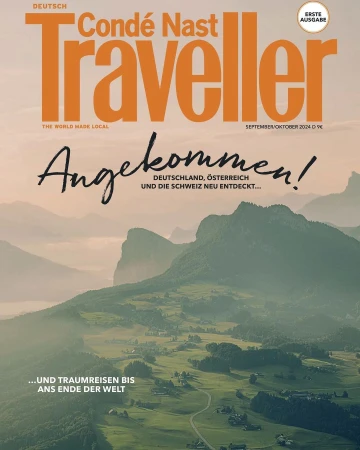 Condé Nast Traveller magazine cover featuring a scenic mountain landscape, showcasing verdant valleys and distant peaks, and magazine text.