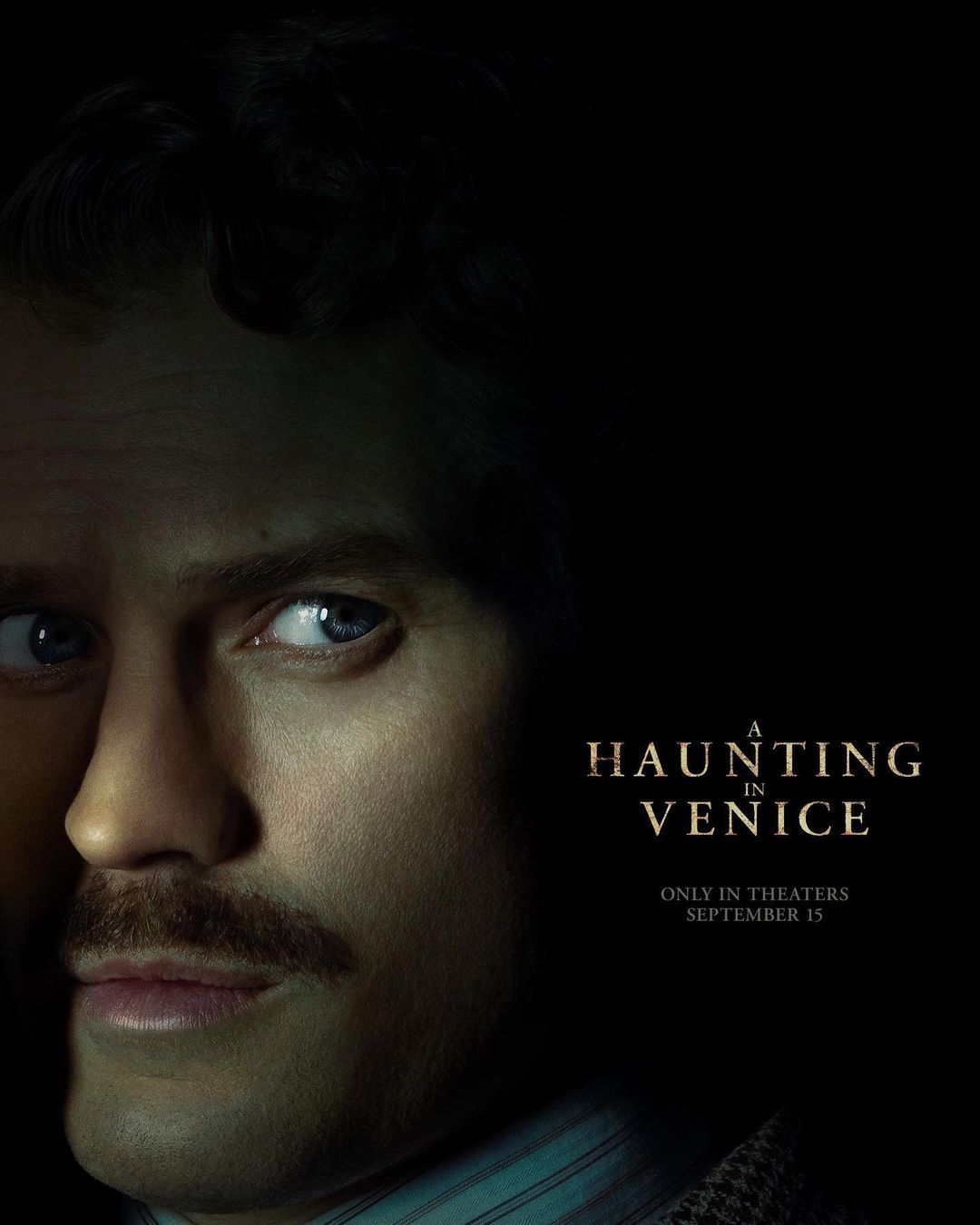 Movie poster featuring a close-up of a man with a mustache and blue eyes, alongside the title 'A Haunting in Venice'.