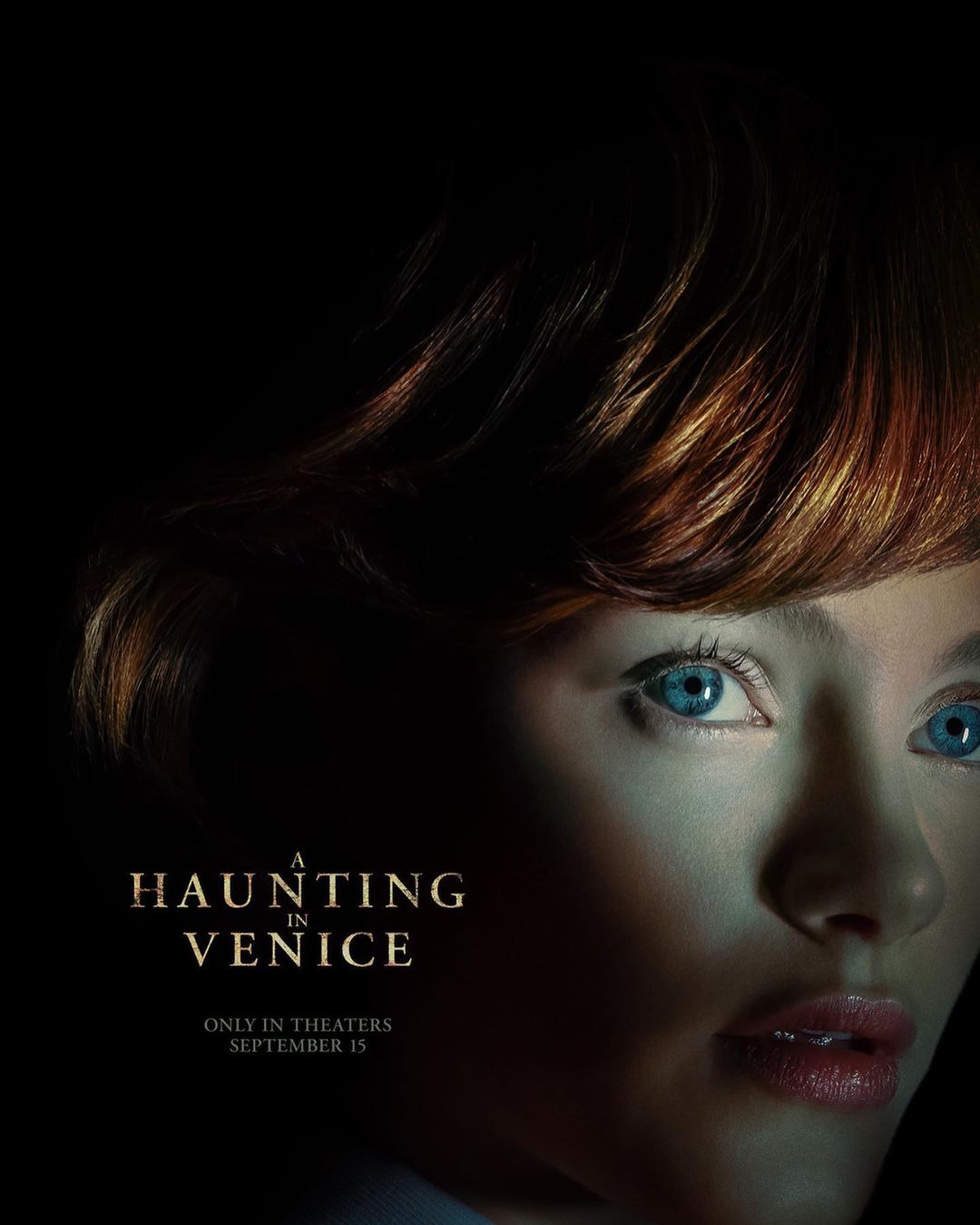 Movie poster for A Haunting in Venice featuring a close-up of a fair-skinned woman with red hair and blue eyes in a dark setting.