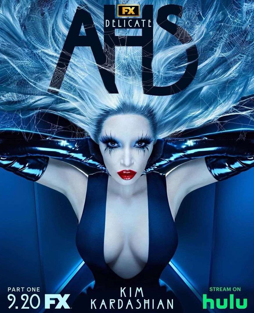 Promotional image for American Horror Story: Delicate, featuring Kim Kardashian with dramatic makeup and hair against a blue backdrop.