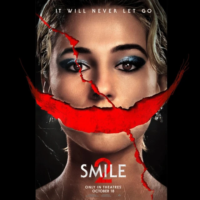 Movie poster for Smile 2 featuring a woman's face with red paint evoking a disturbing smile, underlaid with text announcing the film's release.