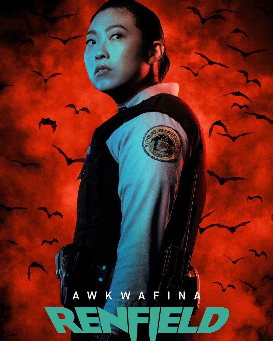Headshot of Awkwafina in character as a police officer against a backdrop of bats and a red sky, promoting the film Renfield.