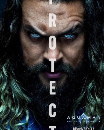 Close-up of Jason Momoa as Aquaman movie poster, featuring a stern expression with long hair, beard, and piercing blue eyes.