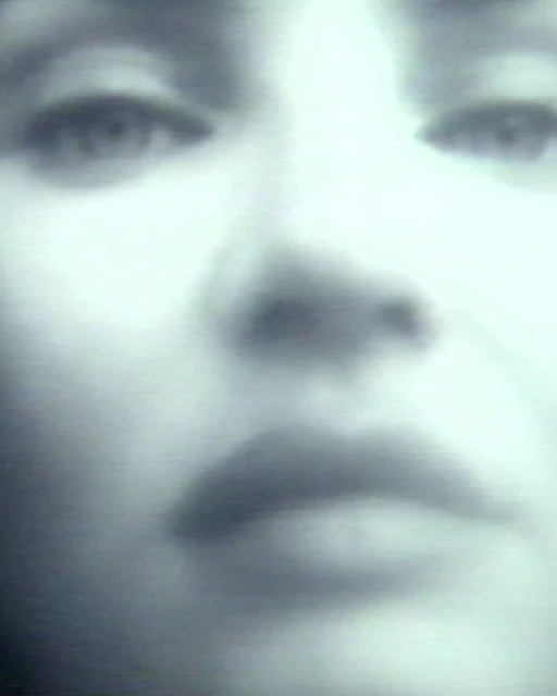 Close-up portrait of an adult female with diffused light, showcasing her face, eyes, nose, and lips in an intimate view.