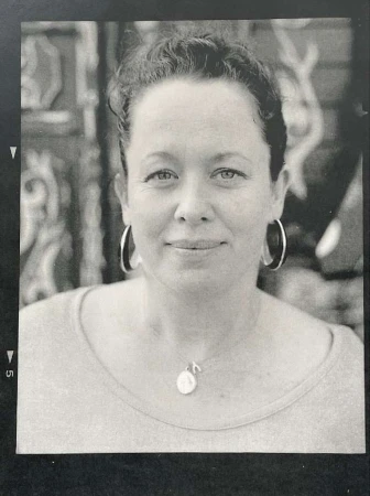 Black and white portrait of a woman wearing hoop earrings and a pendant necklace by photographer Perry Ogden