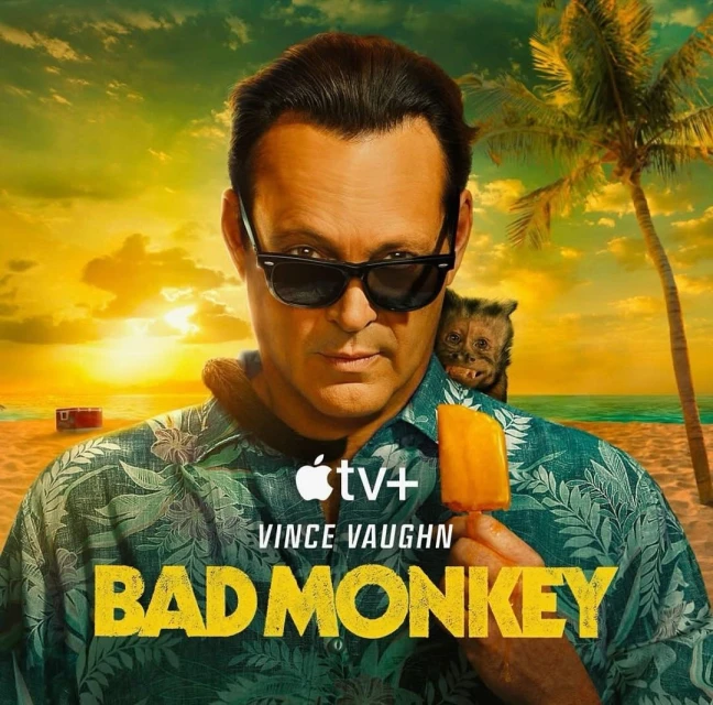 Poster for the TV series 'Bad Monkey' features Vince Vaughn in sunglasses and a tropical shirt, with a monkey on his shoulder, on a beach.