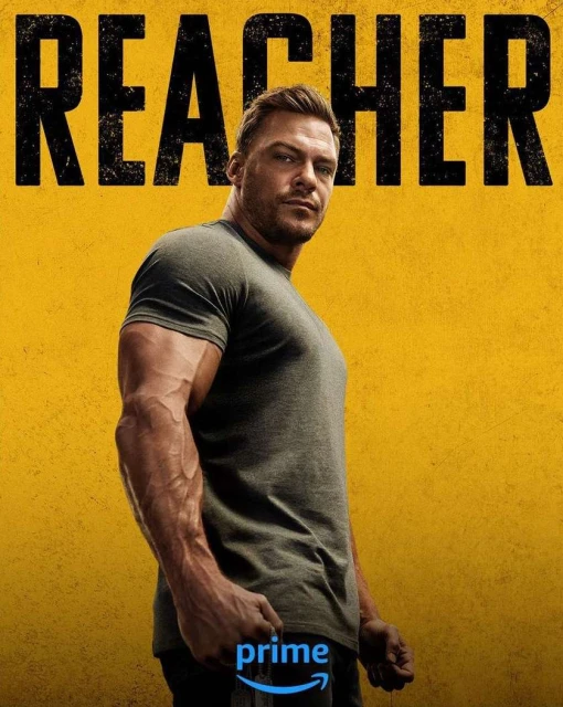 Promotional shot of actor Alan Ritchson for Reacher TV series, wearing a grey shirt against a yellow background with the show logo.