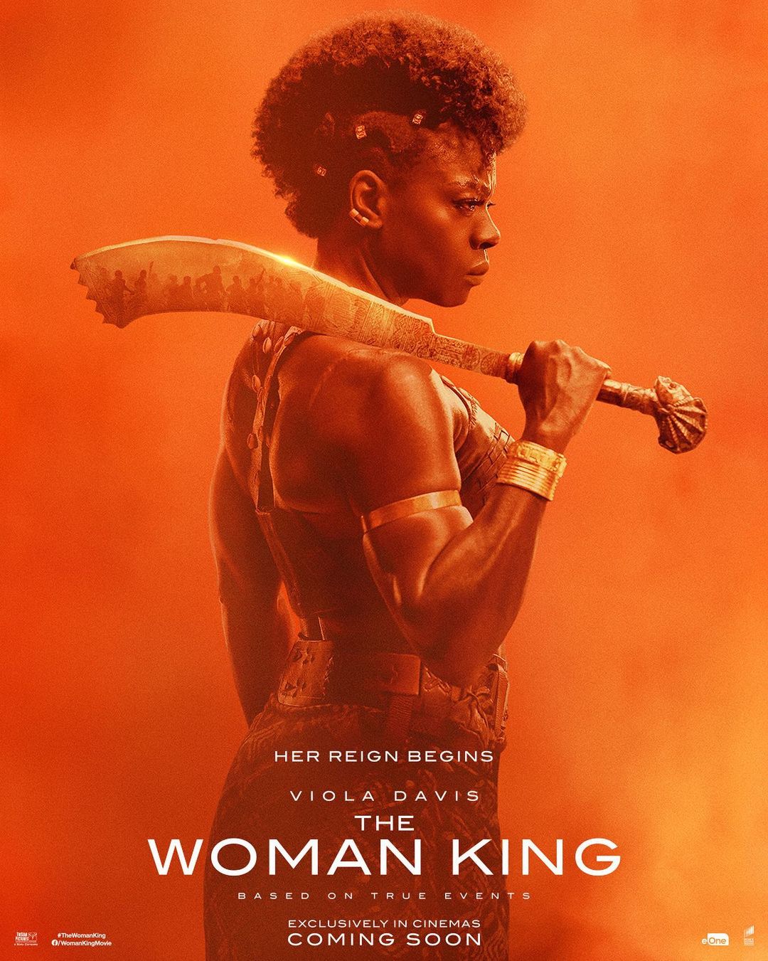Movie poster for The Woman King features Viola Davis with sword, set against an orange backdrop promoting the historical action drama.