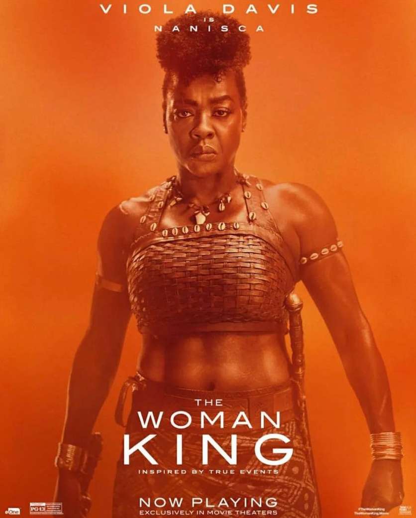 Poster for 'The Woman King' movie featuring Viola Davis, against a warm orange background, showcasing her strength and warrior attire.