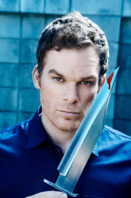 Headshot of a man with dark hair holding a large knife with a drop of blood on the blade, set against a textured blue background.