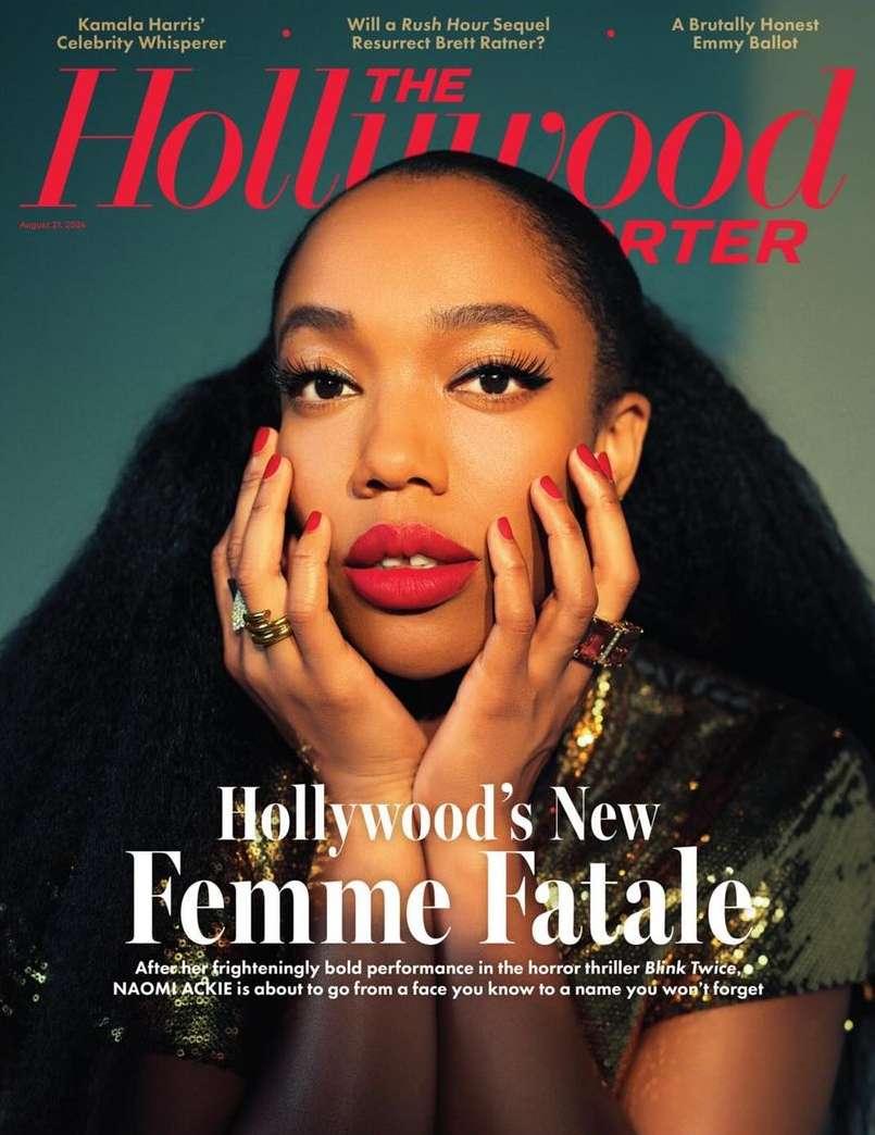 Close-up magazine cover shot of Naomi Ackie with dark hair and red lipstick, with hands framing her face and shoulders in gold sequin top.