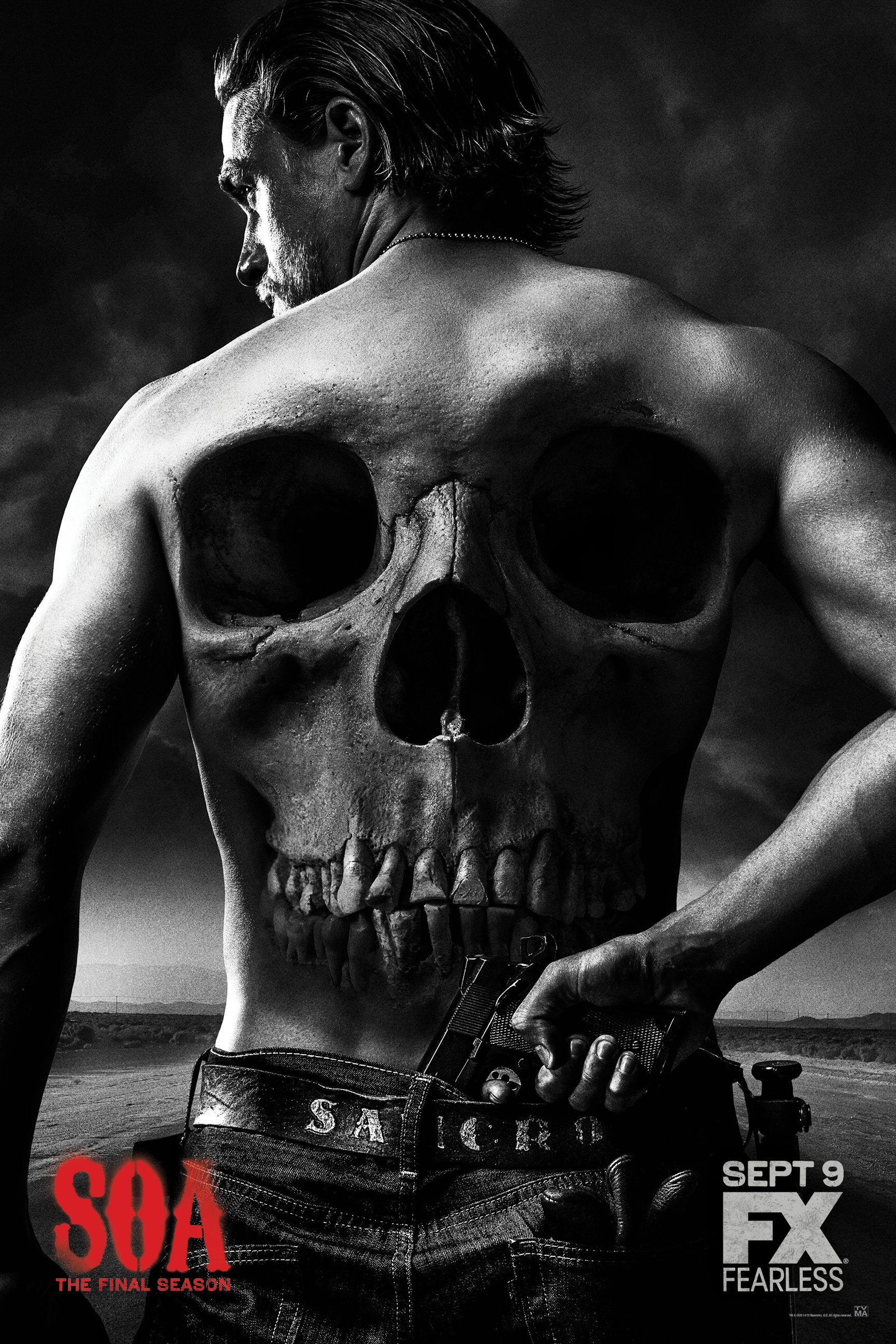 Poster for Sons of Anarchy: final season, featuring a man with a skull tattoo on his back holding a handgun, set against a road.