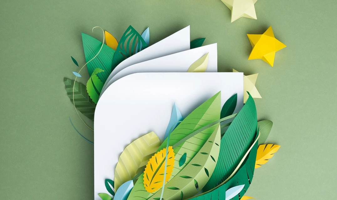 Paper art book with green leaves and yellow stars. Artistic book cover with green and yellow leaves on green background.