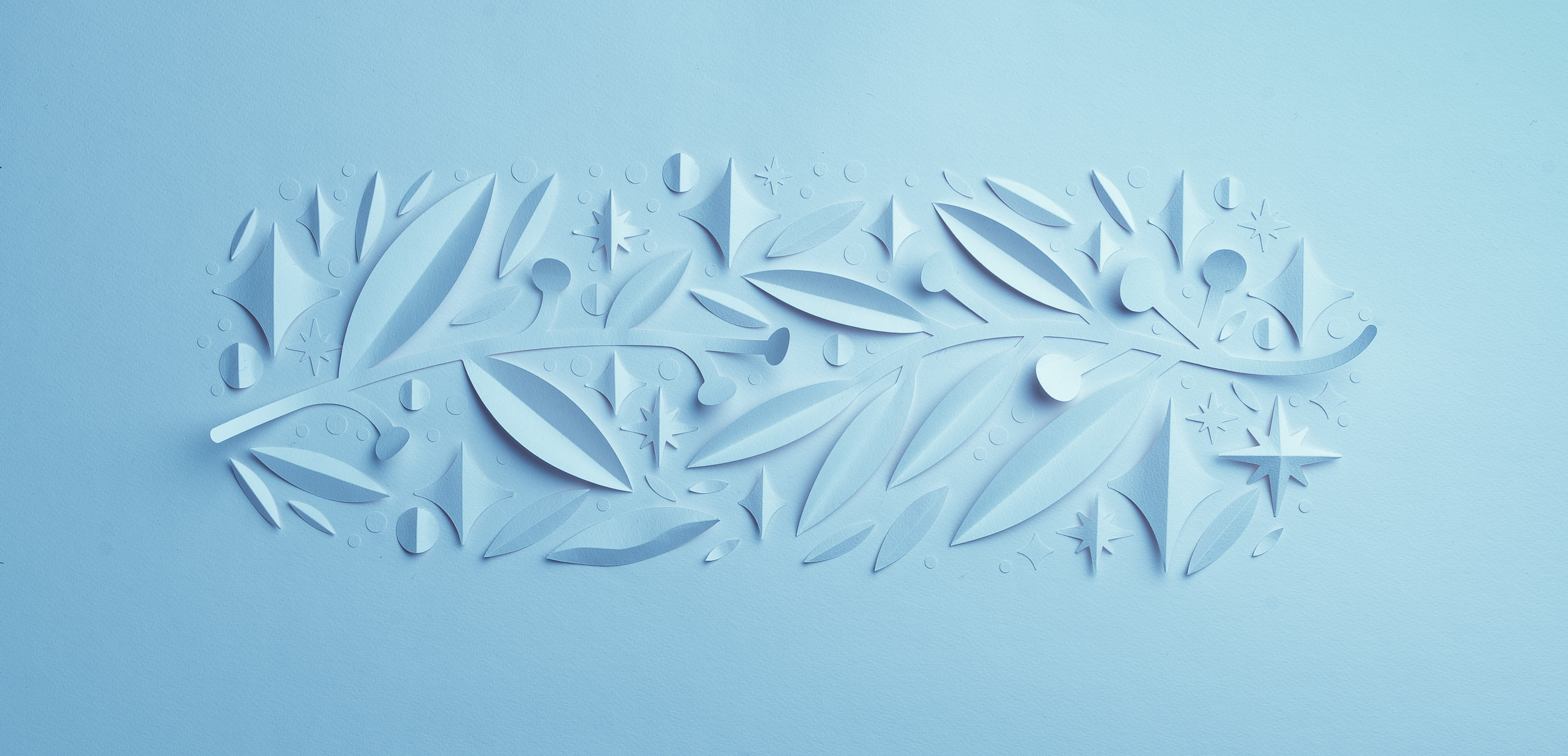 Delicate paper art of leaves and stars in a light blue hue, perfect for artistic backgrounds or creative design projects.
