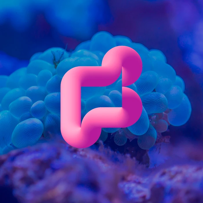 A smooth, tubular hot pink 3D letterform centered against a soft blue underwater coral background.