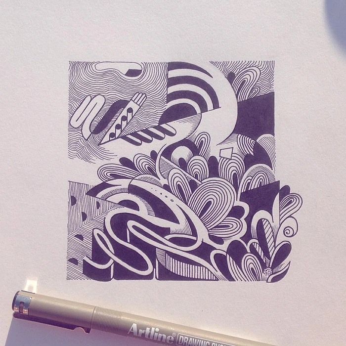 Abstract ink drawing with intricate curved lines and geometric patterns on white paper next to a grey Artline fineliner pen.
