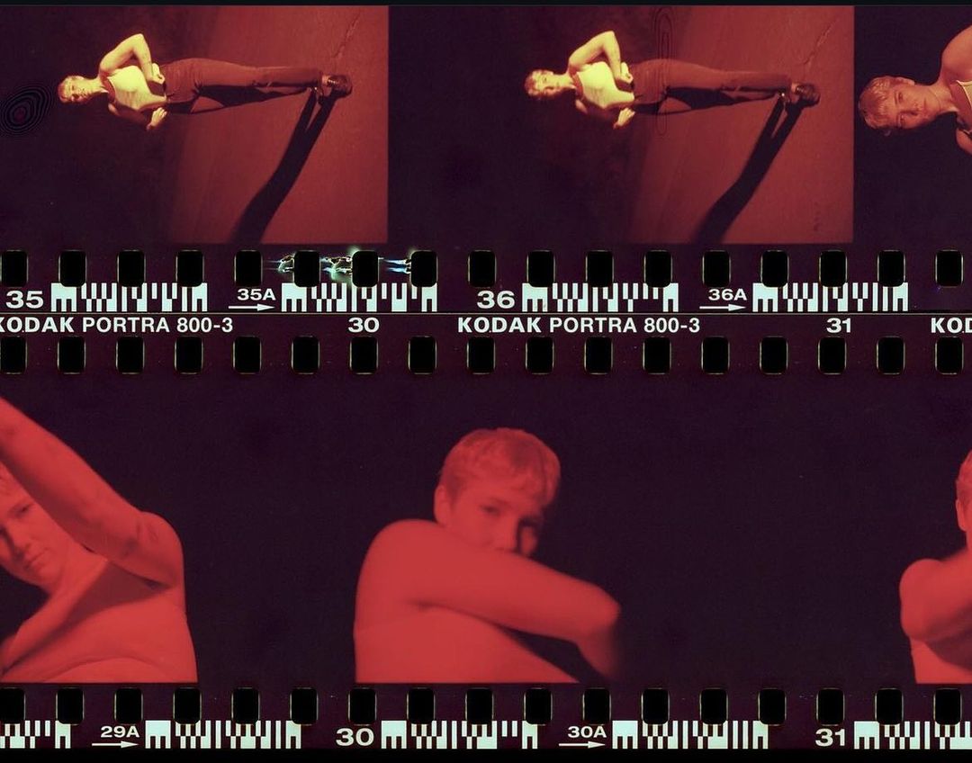 Film strip with a woman posing in several frames in a red tinted environment. The film strip includes KODAK PORTRA 800-3 markings.